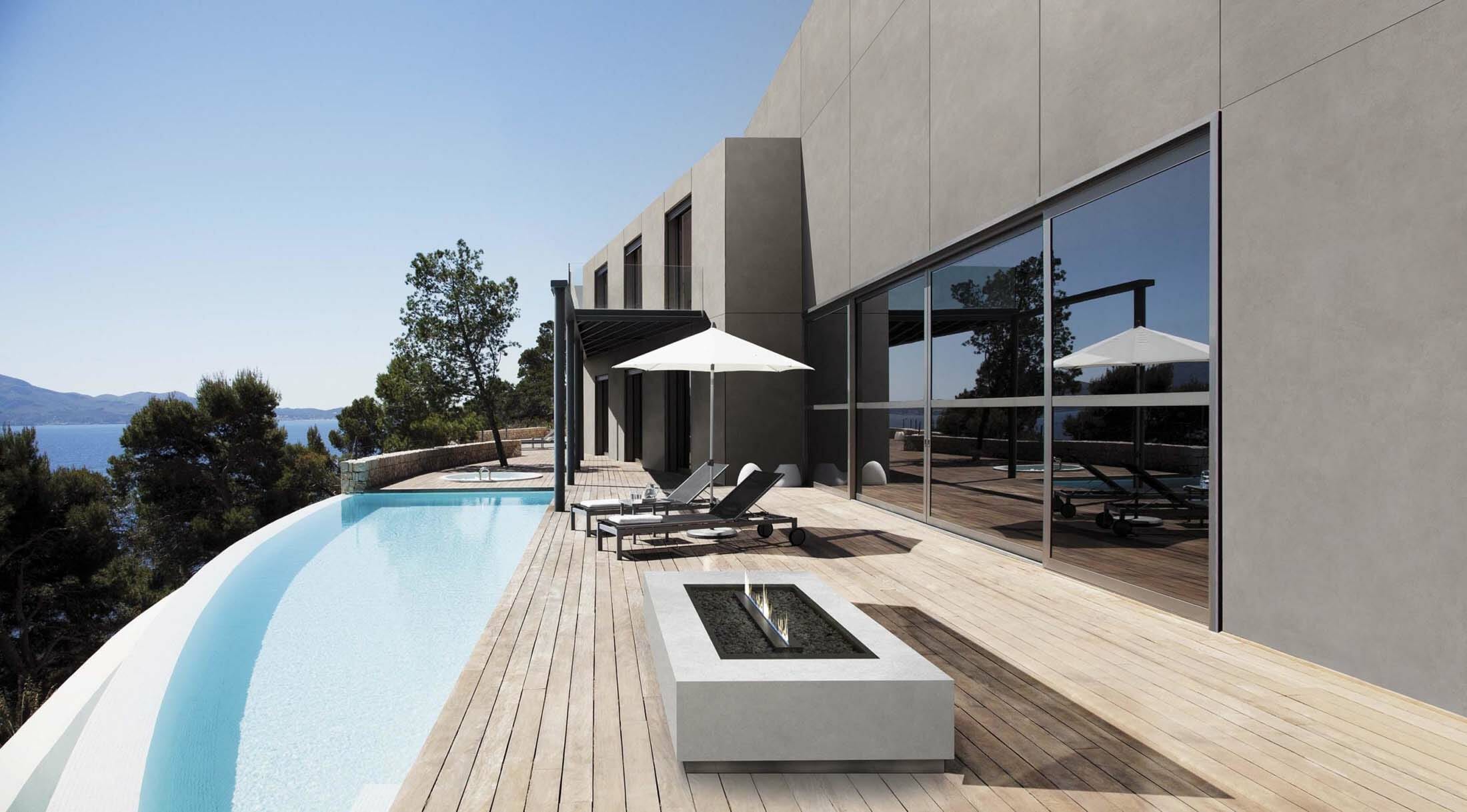 Lounge chairs and pool outside modern house